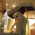 26” h x 18”, the Rolling pin was used in preperation of daily lunch at the Queensbury NY, high school for over 35 years. The antique water bottle was exploded as part to the Off the Table series, welded together with chandelier piece and structure, left in found finish.