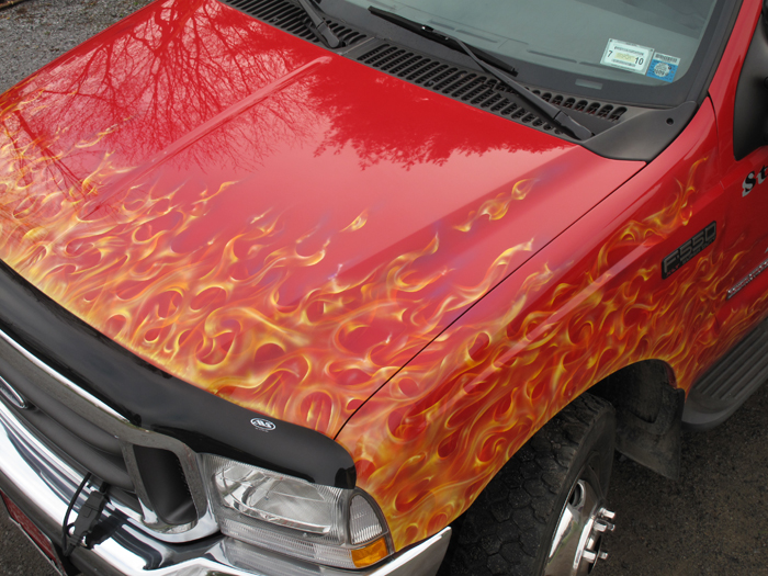 tow truck airbrushed with real flames on red