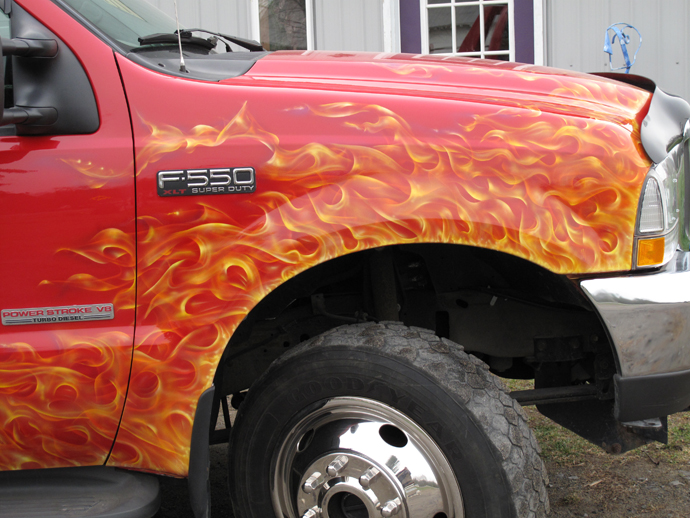 tow truck airbrushed with real flames on red